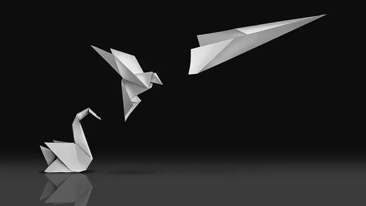 Crumpled paper on black background, transforms into a bird and then into a paper plane (no Superman, unfortunately)